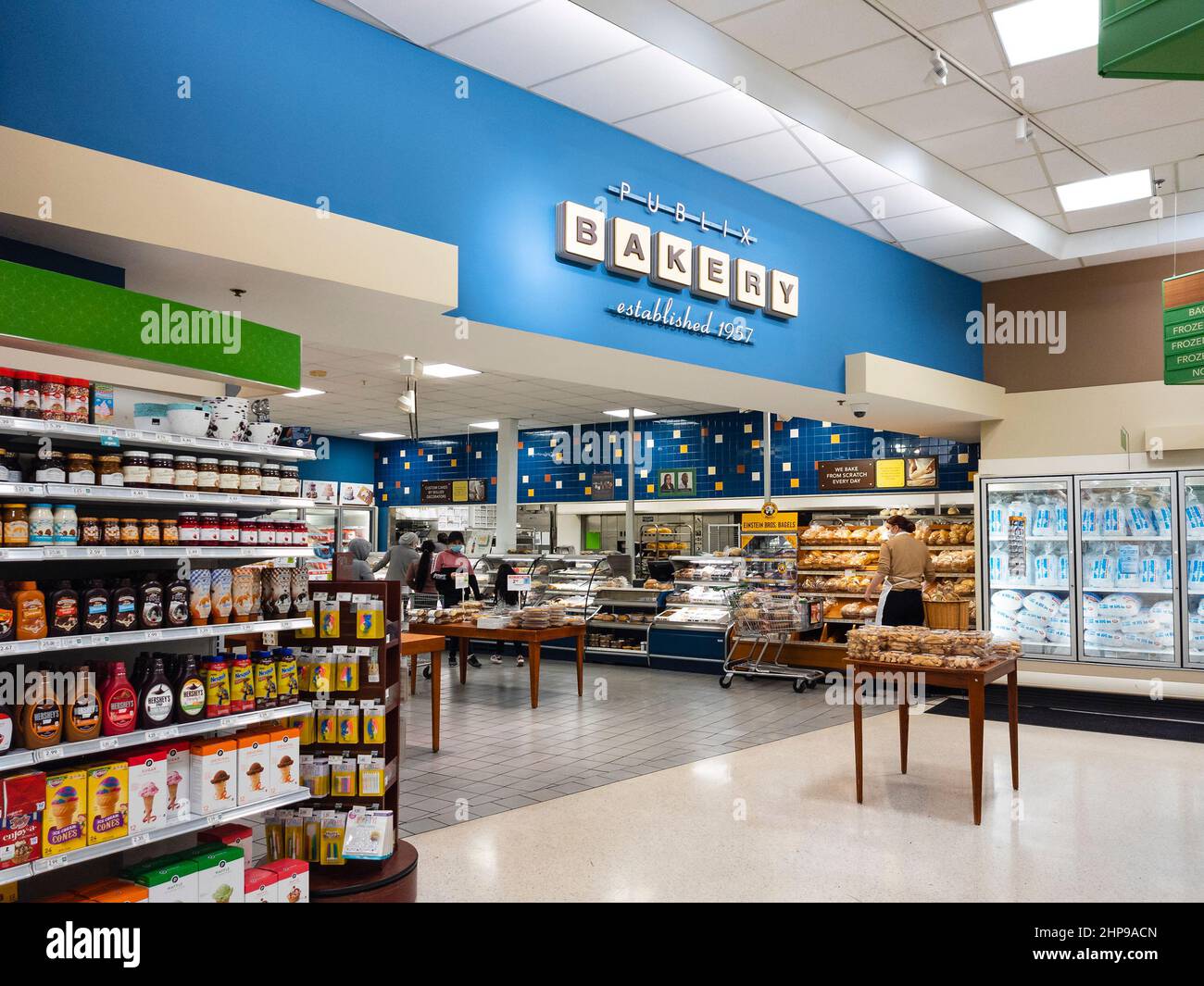 Orlando, Florida - February 8, 2022: Horizontal Indoor View of Publix Bakery with a Store Attendant Stacking Bread. Stock Photo