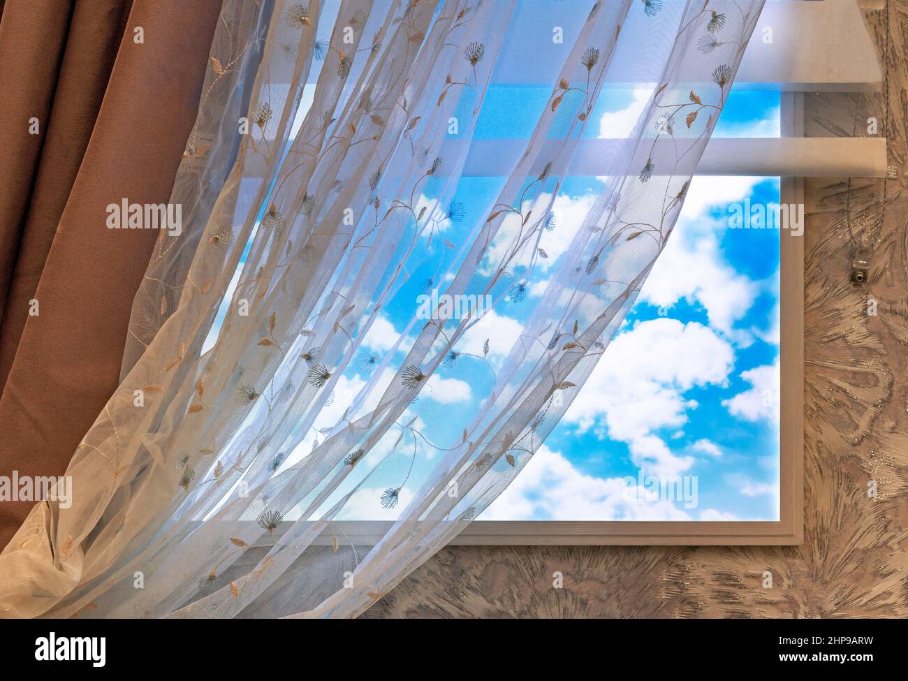 Curtan and transparent tulle on the window with clouds. Stock Photo