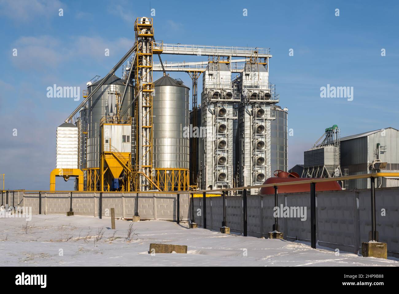 agro silos granary elevator in winter day in snowy field. Silos on agro