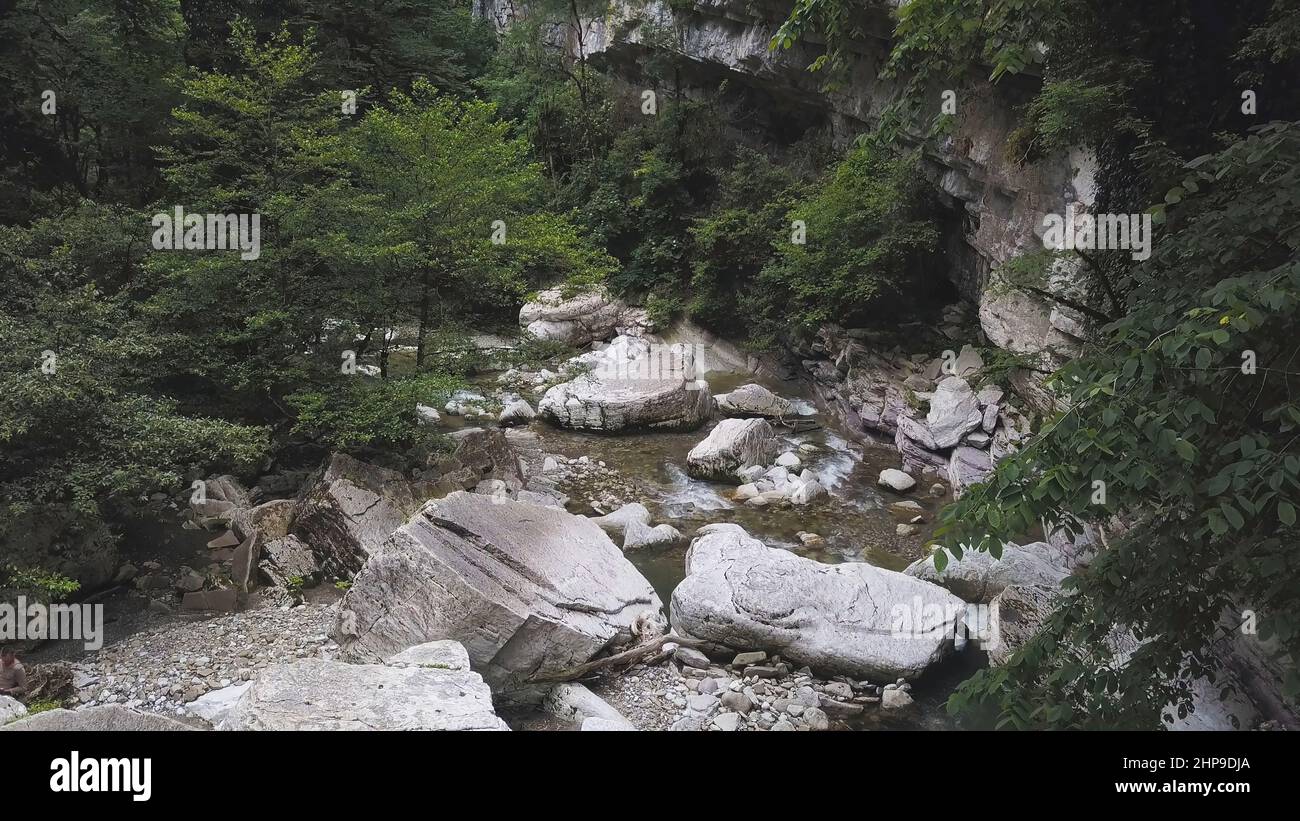 Aerial view of a mountainous river flowing through green forest. Nature ...