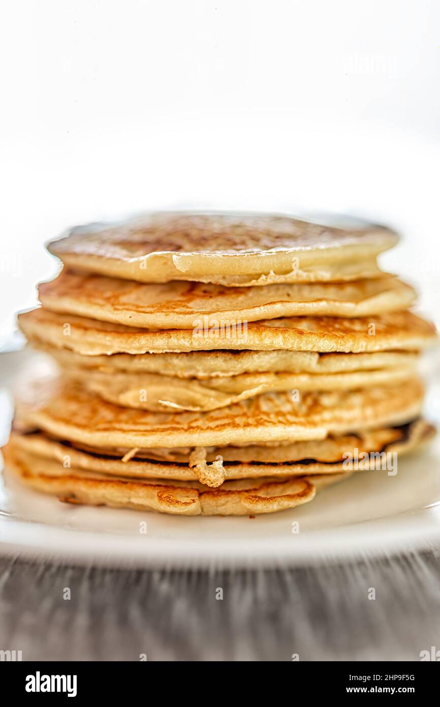 Macro closeup side view of stack of buttermilk plain pancakes on plate