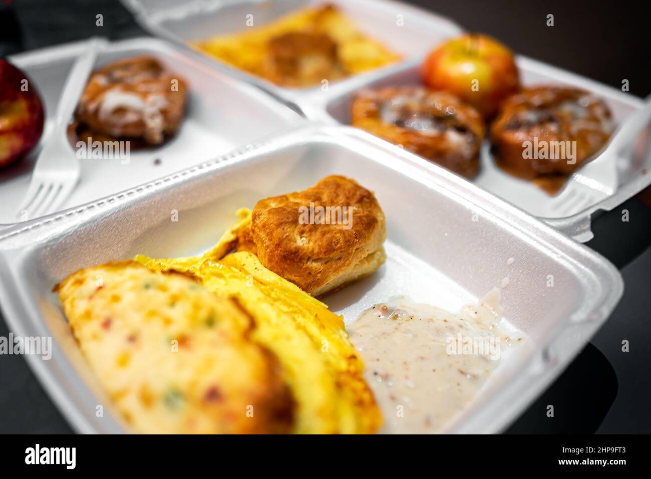 Fresh hot buffet styrofoam tray with breakfast food eggs omelette from free morning continental