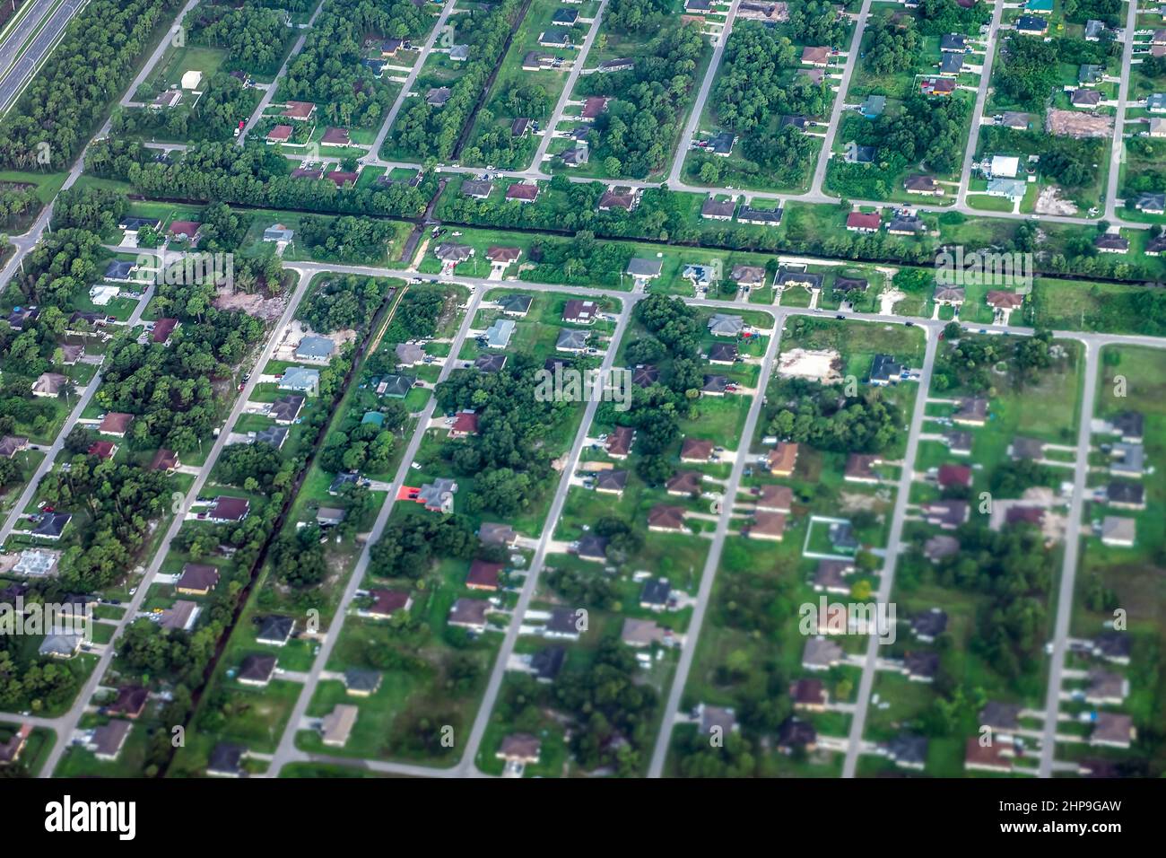 Airplane aerial point of view from window of Fort Myers, Florida, USA city town houses roof buildings in morning residential neighborhood Stock Photo