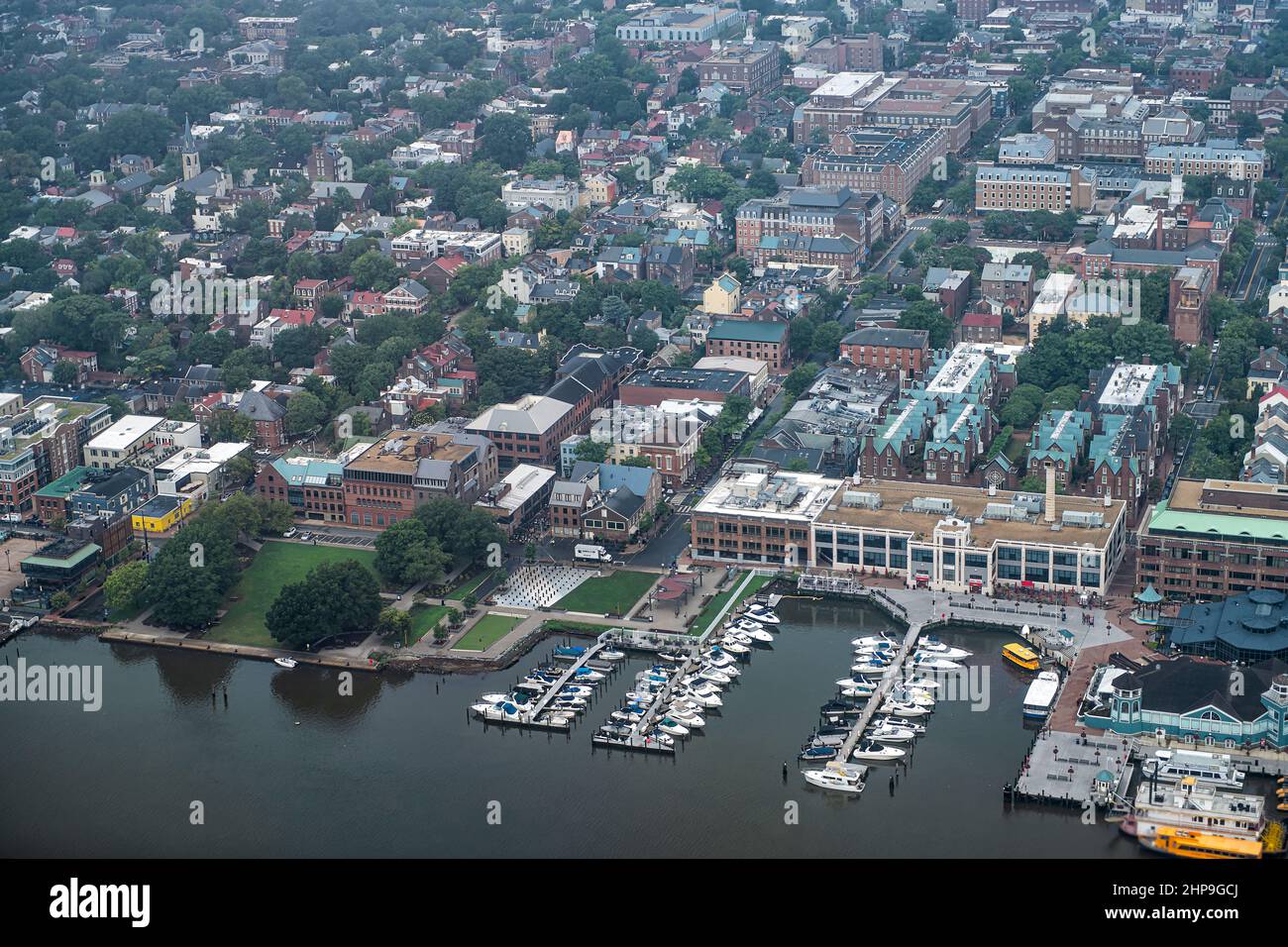 Plane aerial drone view of Alexandria cityscape in Northern Virginia on a cloudy day near Washington DC Potomac river descending to Reagan National Ai Stock Photo