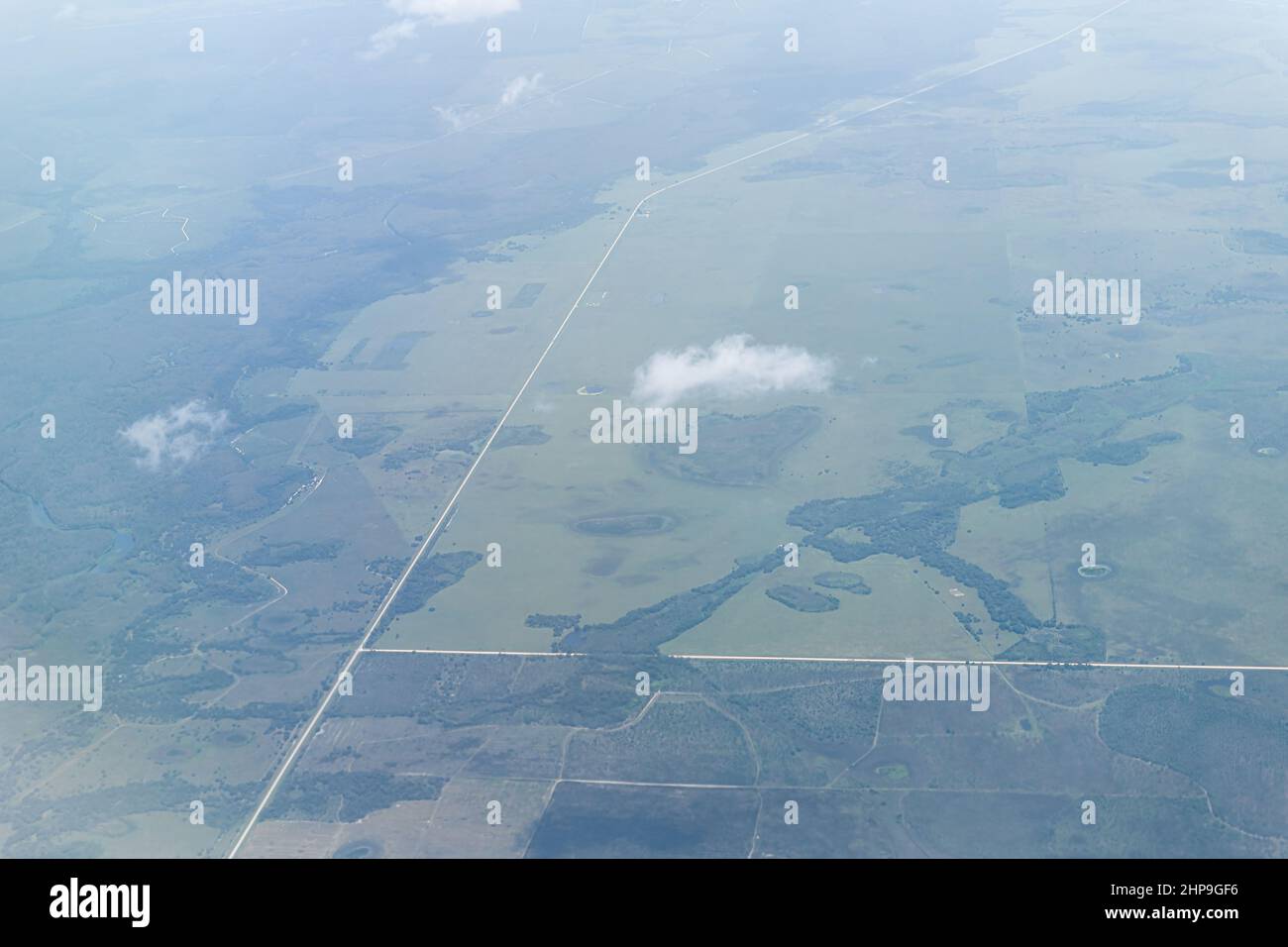 High angle aerial view of southwest Florida near Ft Myers countryside landscape with farm fields and clouds Saharan dust plume air layer causing haze Stock Photo