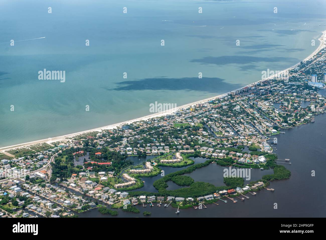 High angle aerial view of Ft Myers beach landscape near Sanibel Island in southwest in Florida Saharan with beautiful green water and houses buildings Stock Photo
