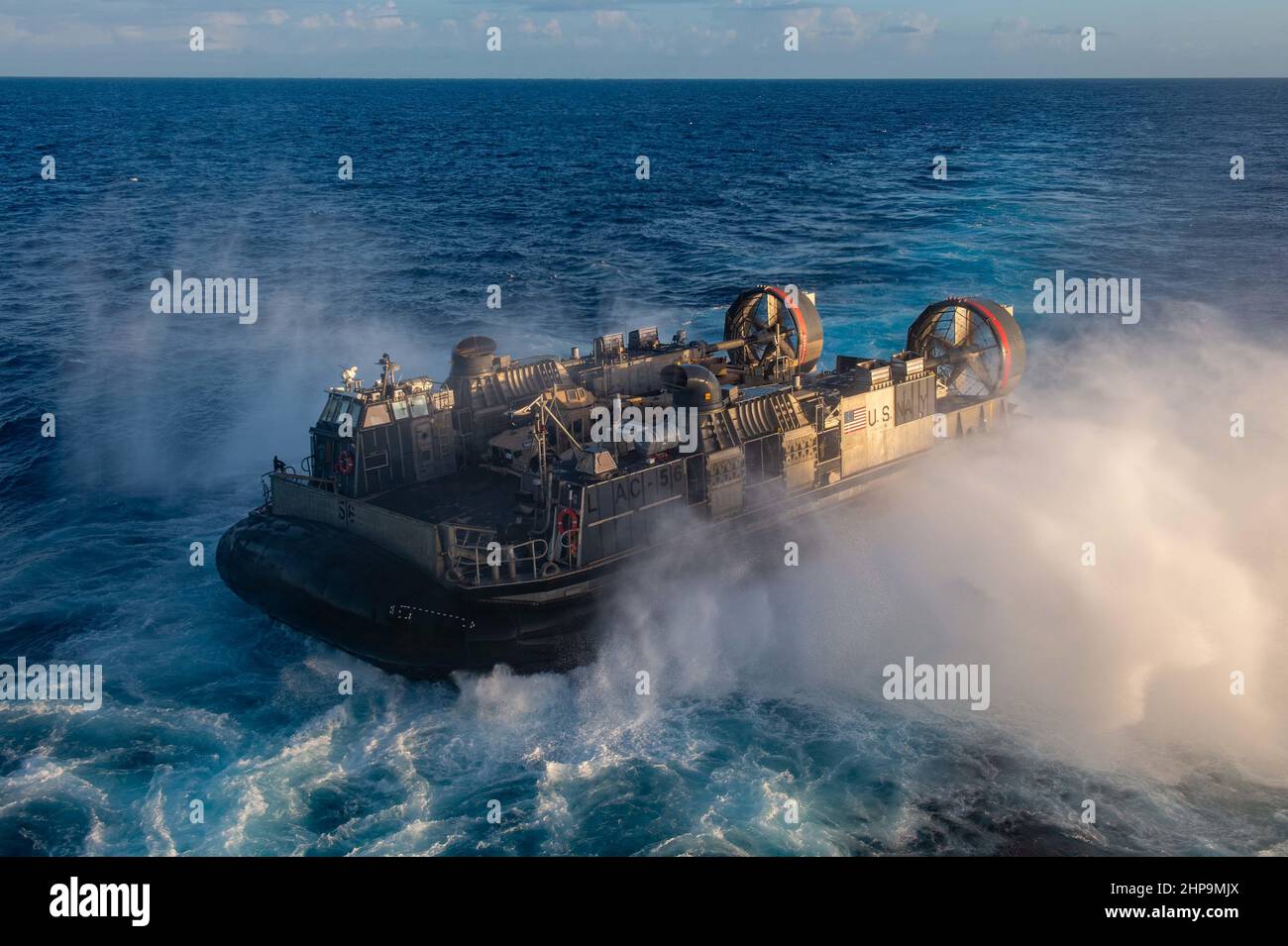 PACIFIC OCEAN (Feb. 18, 2022) Landing craft, air cushion attached to Assault Craft Unit (ACU) 5, conducts well deck operations with Wasp-class amphibious assault ship USS Essex (LHD 2), Feb. 18, 2022. Sailors and Marines of Essex Amphibious Ready Group (ARG) and the 11th MEU are underway conducting routine operations in U.S. 3rd Fleet. (U.S. Navy photo by Mass Communication Specialist 3rd Class Isaak Martinez) Stock Photo