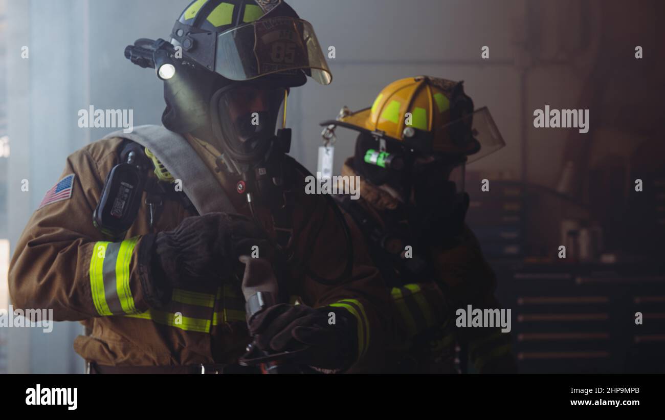 U.S. Air Force firefighters assigned to the 379th Expeditionary Civil Engineer Squadron simulate putting out a structure fire at Al Udeid Air Base, Qatar, Feb. 16, 2022. During Grand Shield 22-3, the installation’s most recent readiness training event, first responders such as security forces, medical and firefighters, responded to various on-base scenarios. (U.S. Air Force photo by Staff Sgt. Stefan Alvarez) Stock Photo