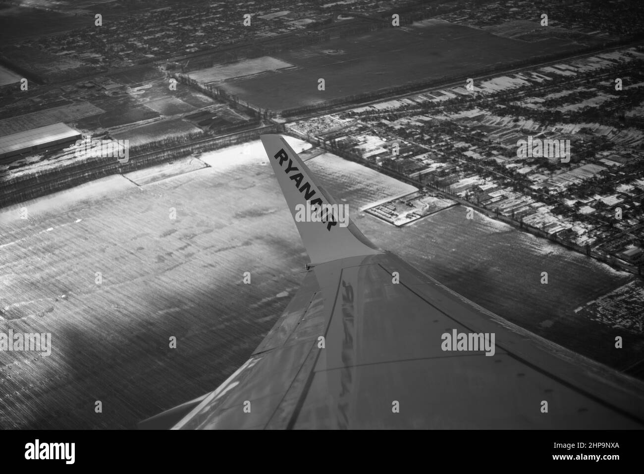 KIEV, UKRAINE - OCTOBER 11, 2022: The wing of the aircraft with the inscription Ryanair in the air autdoor Stock Photo