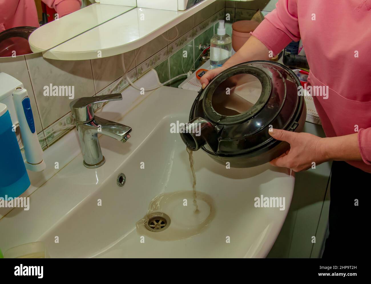 The process of cleaning the carpet with a vacuum cleaner with a water