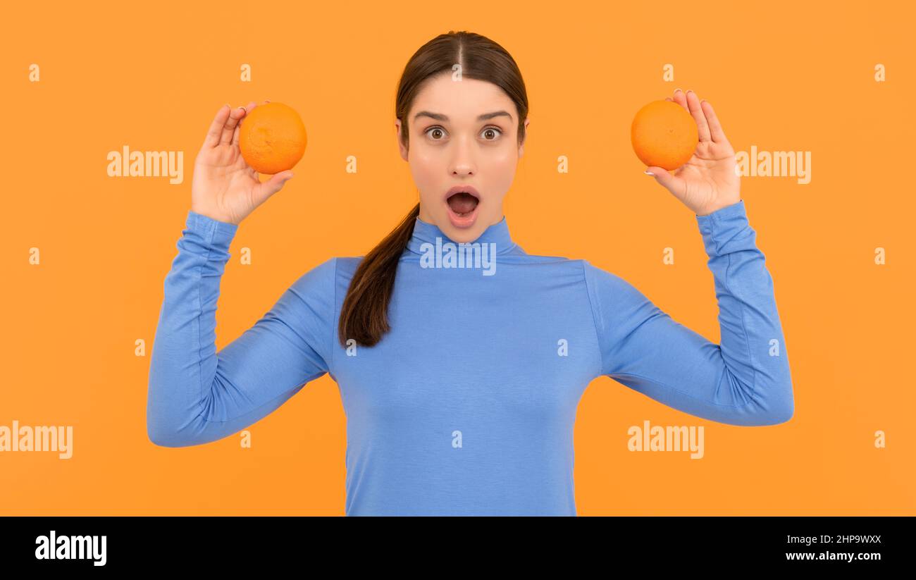 surprised woman holding healthy food. health by natural organic fresh grapefruit. Stock Photo