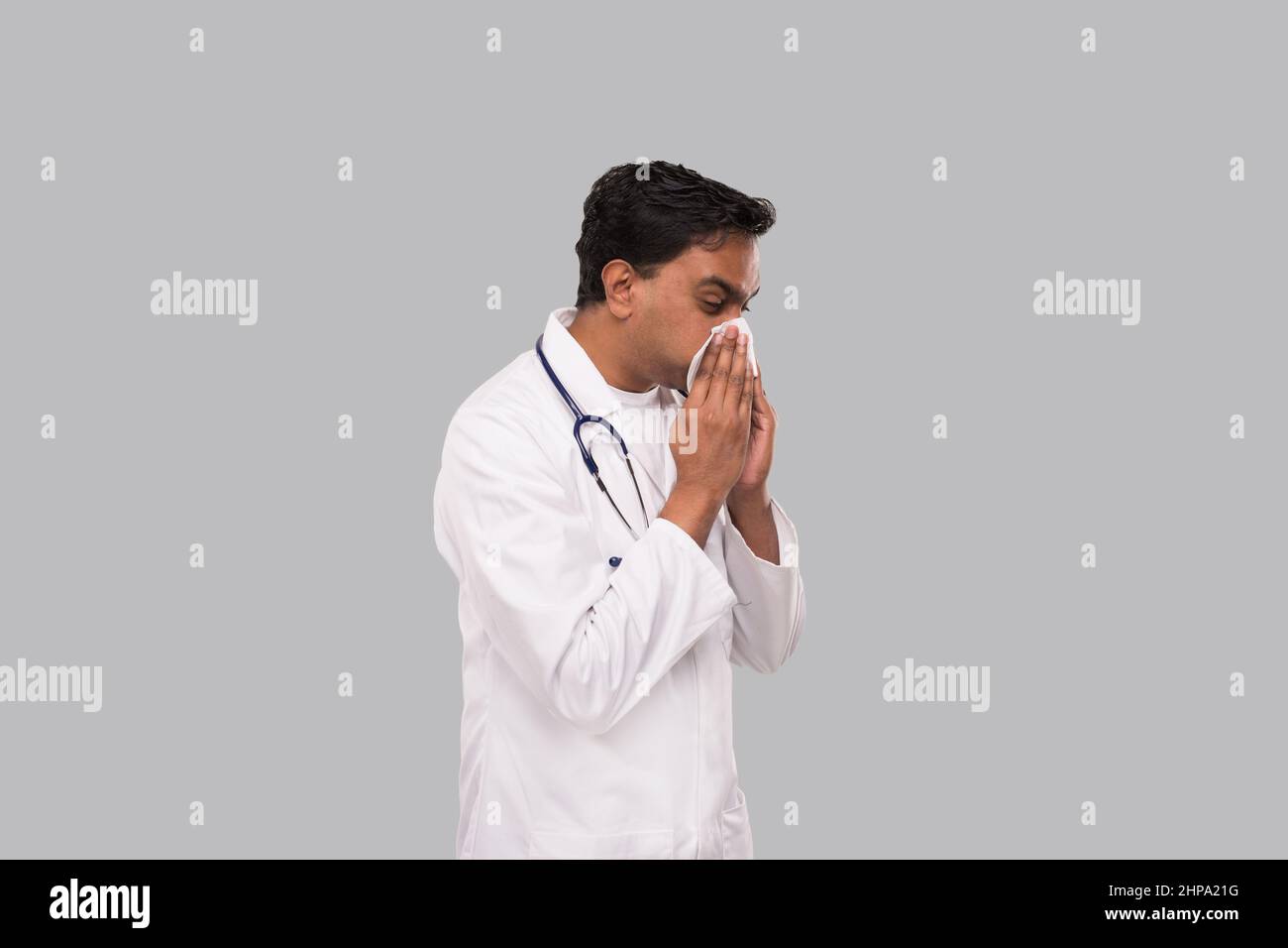 Doctor Sneezing. Doctor Blowing Nose Isolated. Medicine, Healthy Life, Virus Concept Stock Photo