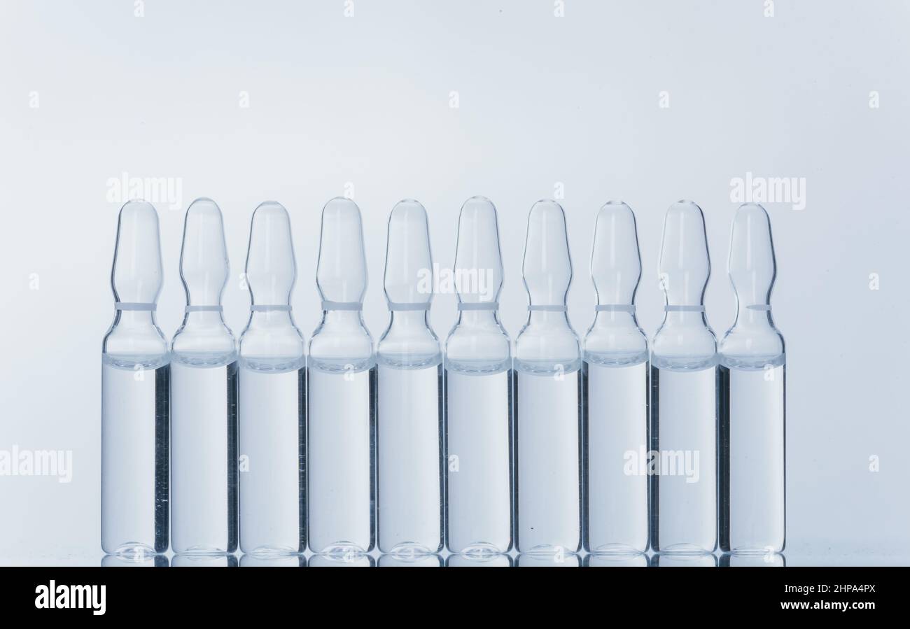 Glass medical ampoule vial for injection. Medicine is dry white drug