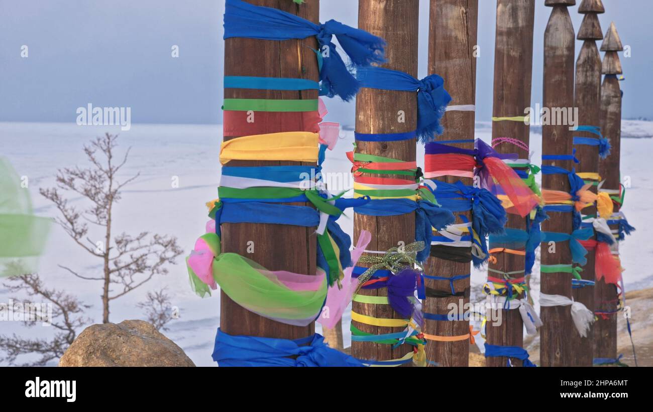 Buddhist Ritual poles with colored ribbons in the winter at the holy ...