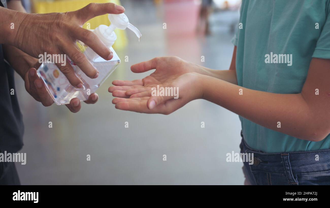 Hand Sanitizer gel. Hand treatment with alcohol. Temperature check at