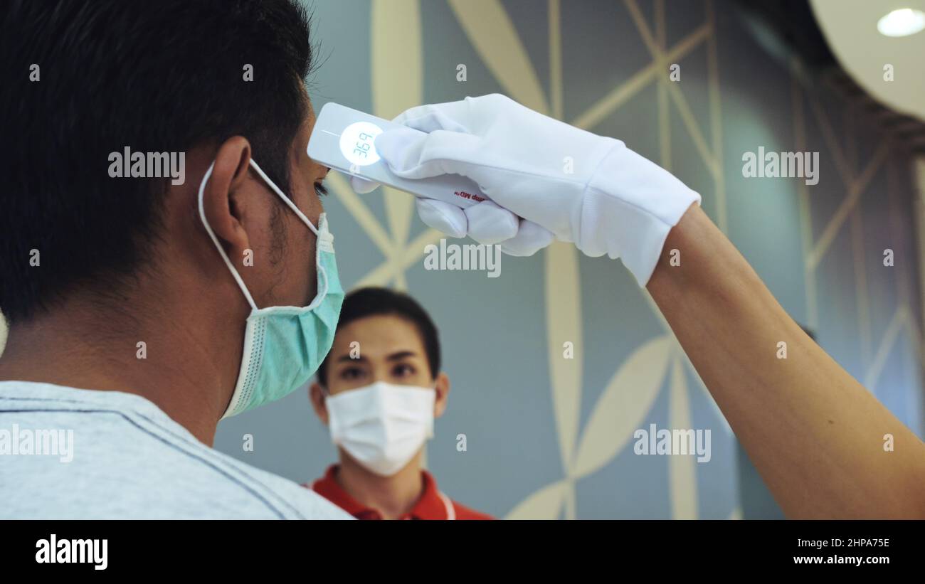 Temperature Check Commercial PATTAYA, THAILAND - MARCH 20, 2020: Temperature check at supermarket ...