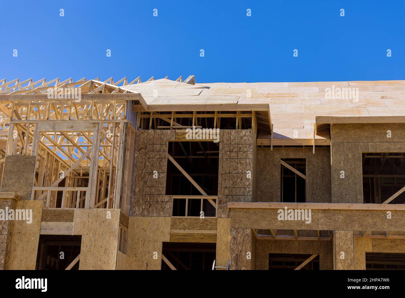 The timber frame beam framework house stick built home under construction new build with wooden truss Stock Photo