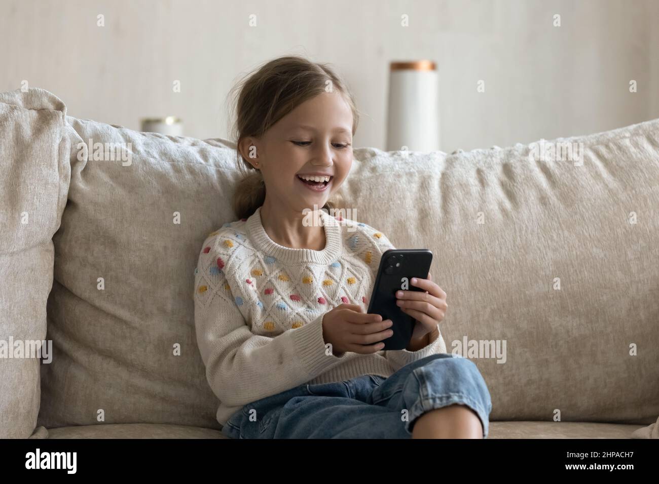 Happy kid talking on video call on smartphone Stock Photo