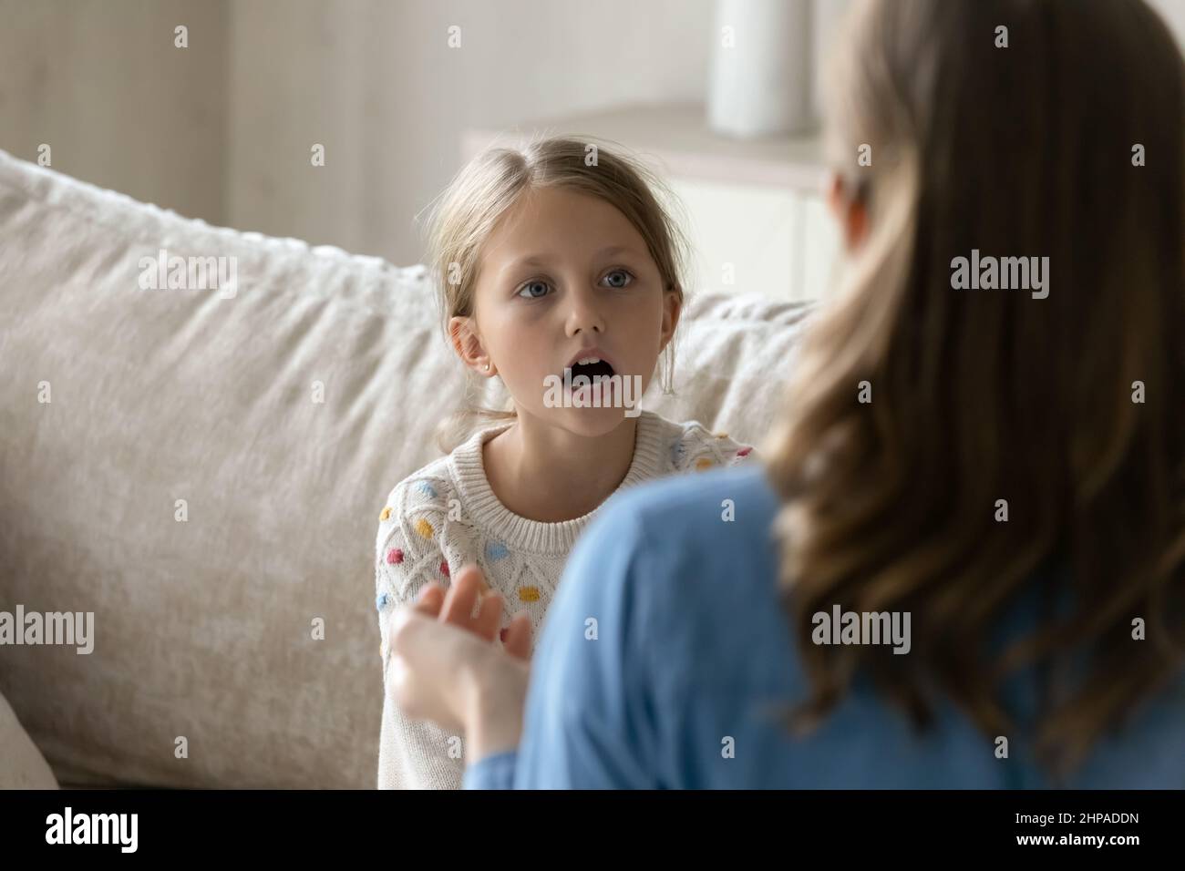 Speech therapist helping kid with pronunciation problems, Stock Photo