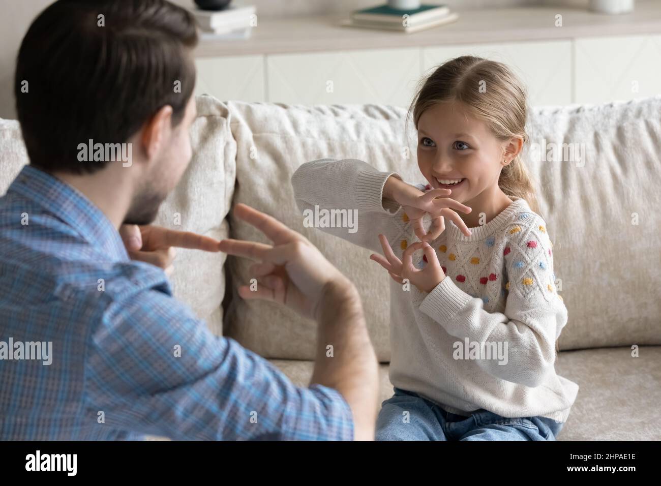Happy pretty daughter kid and father talking with gestures Stock Photo