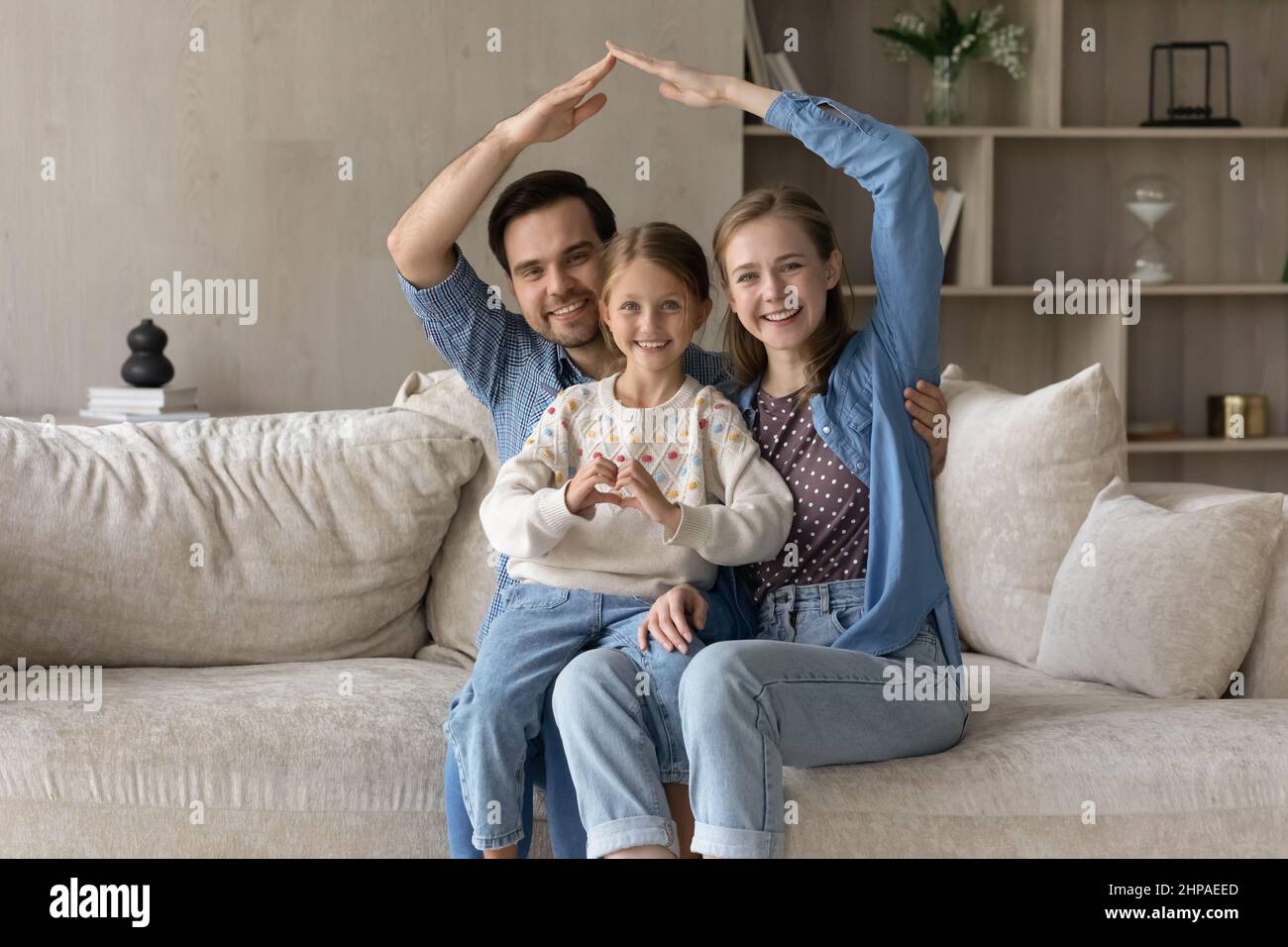 Happy family couple and cute child home portrait Stock Photo - Alamy