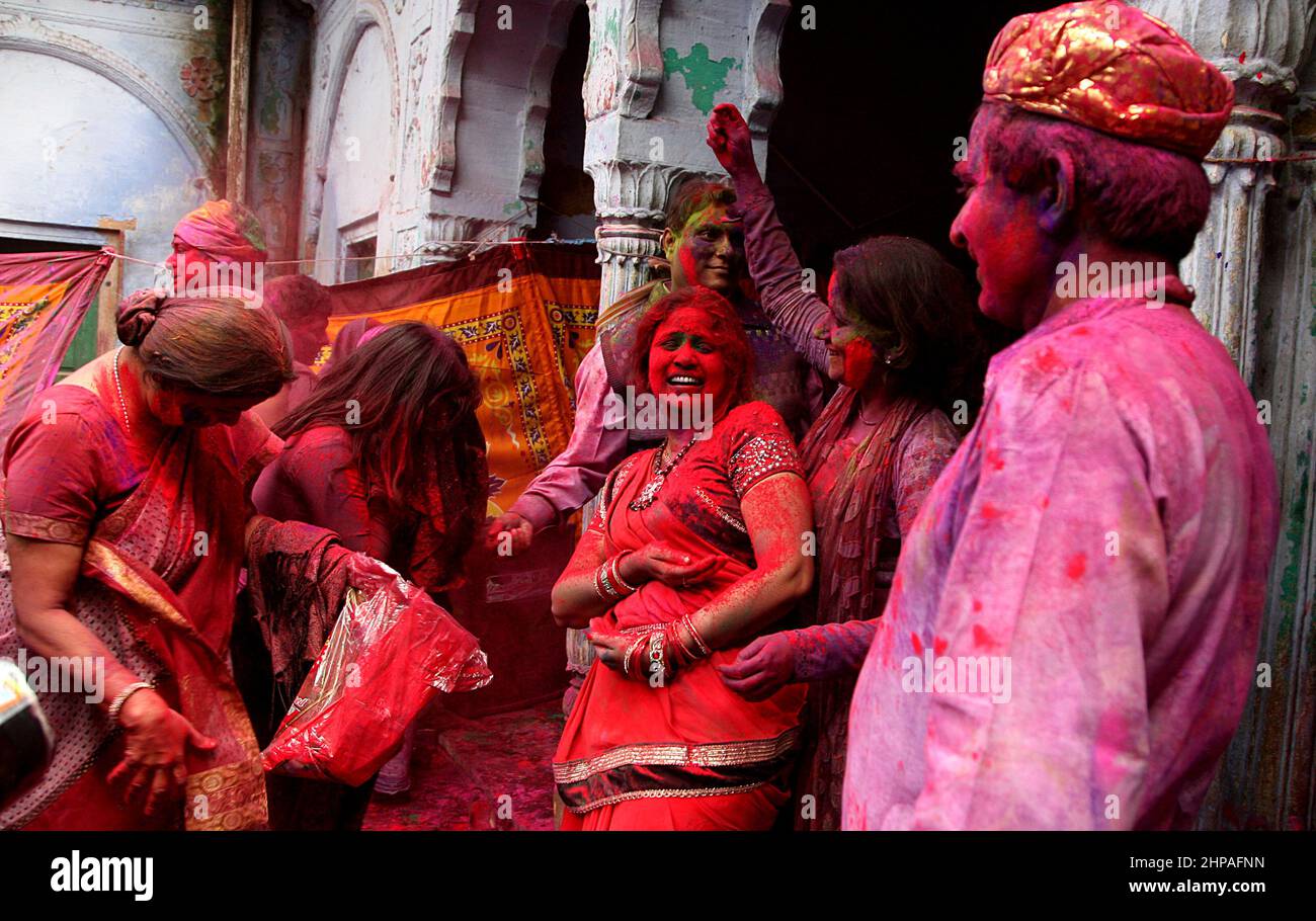 Indian girls and women celebrate Holi festival with the widows in a old age home for widows in Vrindavan in India, 2015. Stock Photo