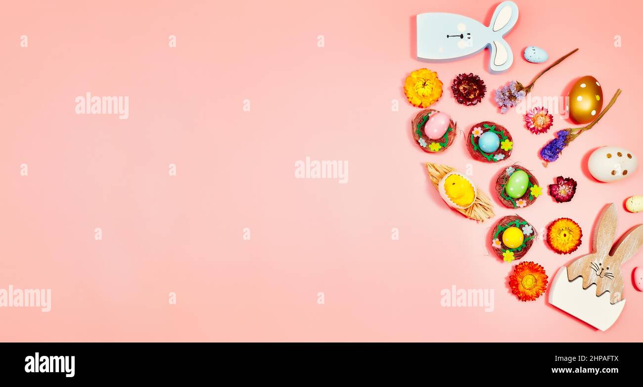Coloeful easter eggs in nest on pink color background with space ...
