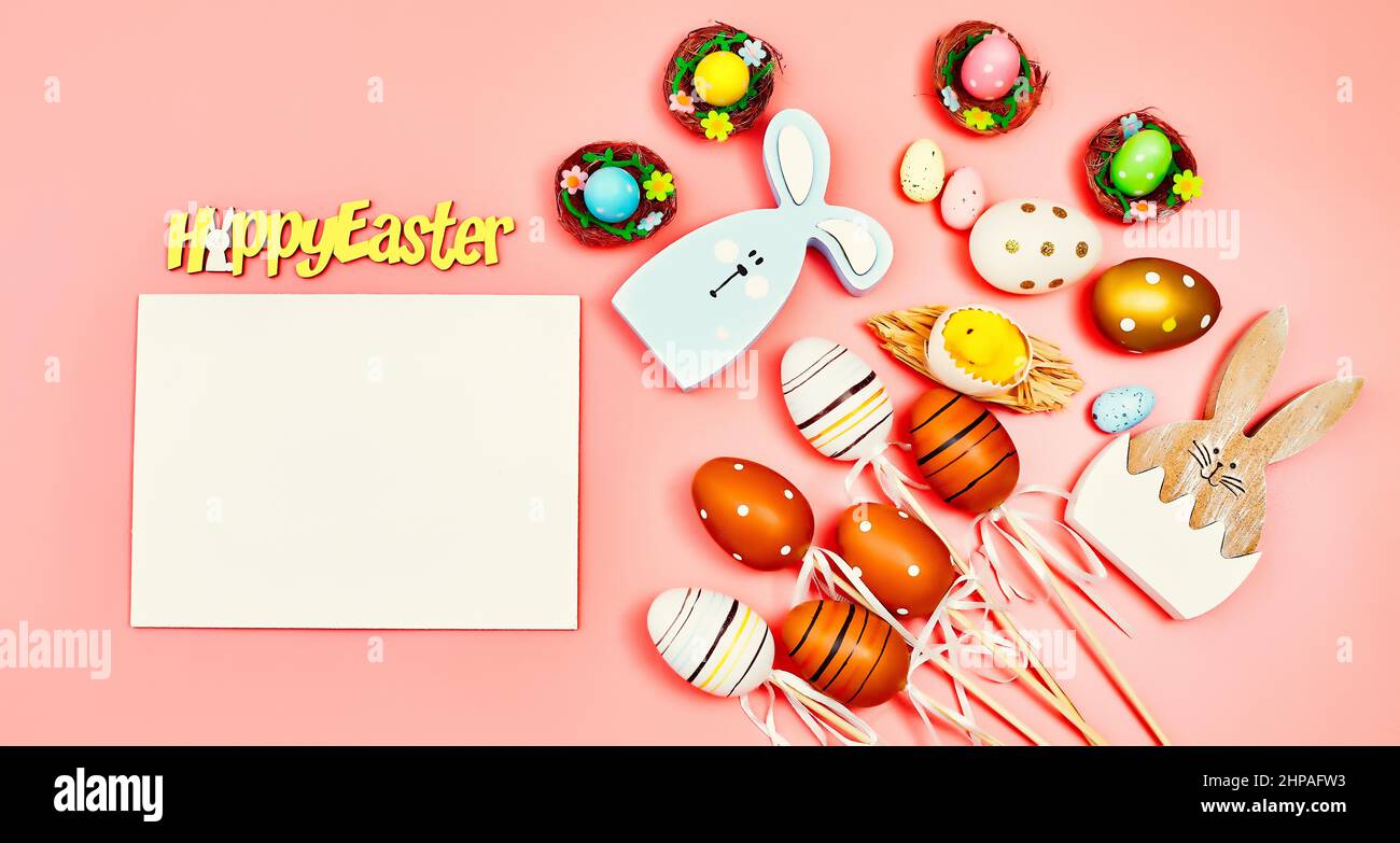 Coloeful easter eggs in nest on pink color background with space ...