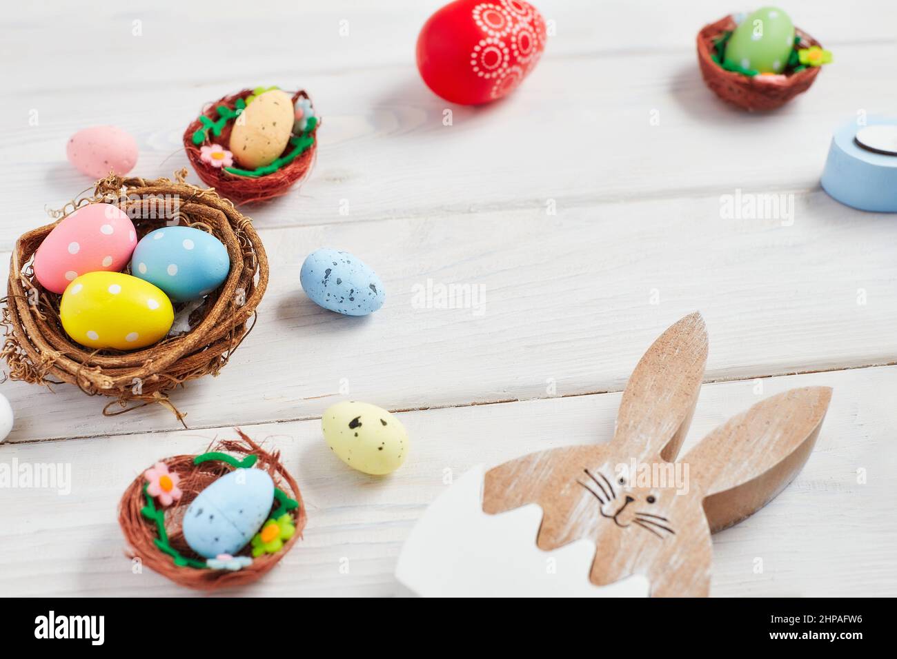 Coloeful easter eggs in nest on pink color background with space ...