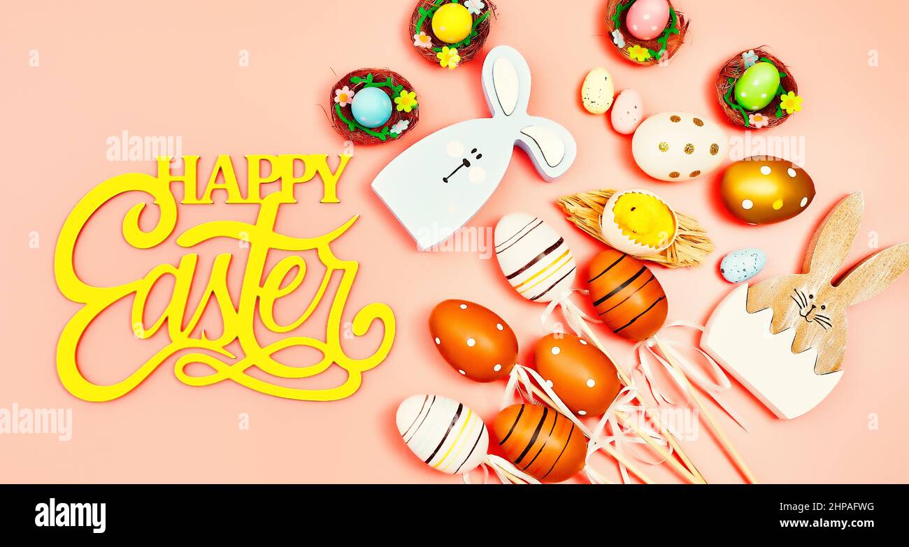 Coloeful easter eggs in nest on pink color background with space ...