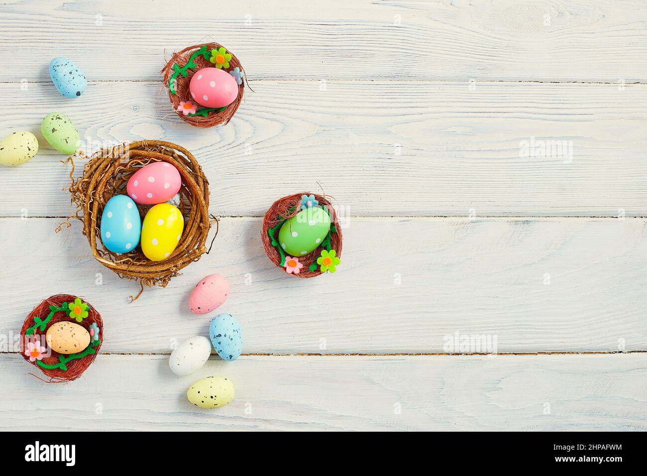 Coloeful easter eggs in nest on pink color background with space ...