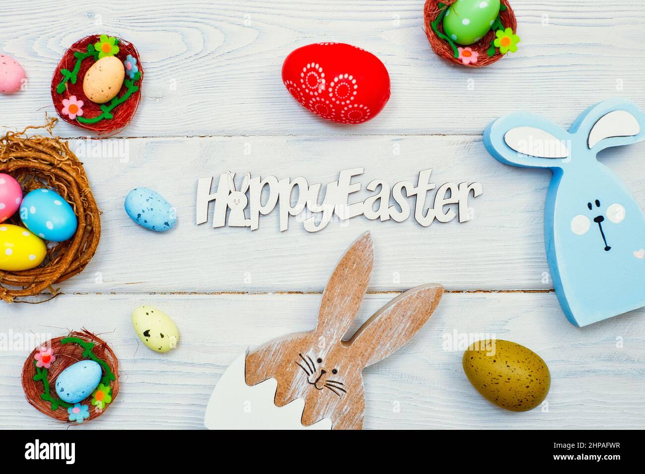Coloeful easter eggs in nest on pink color background with space ...