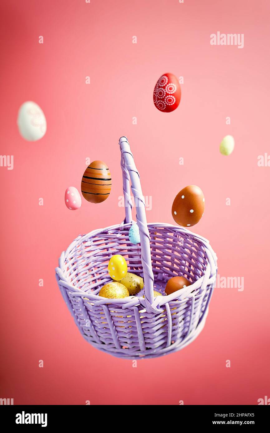 Easter eggs falling into a flying basket, Easter holiday concert Stock Photo