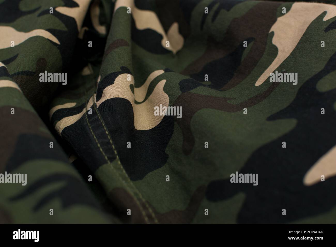 Military camouflage green, black, brown and beige uniform, background, close up Stock Photo