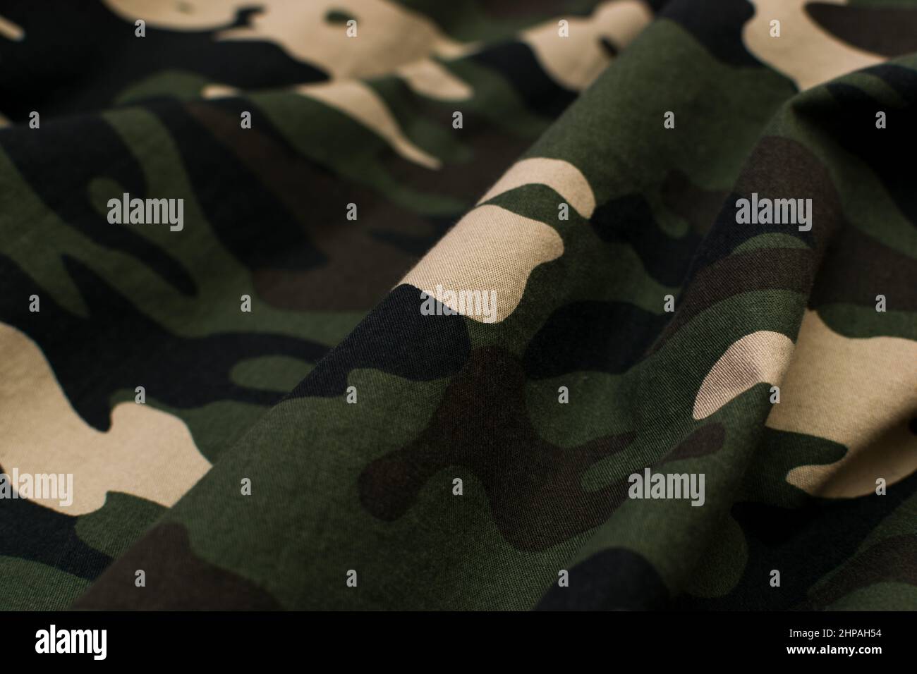 Military camouflage green, black, brown and beige uniform, background Stock Photo