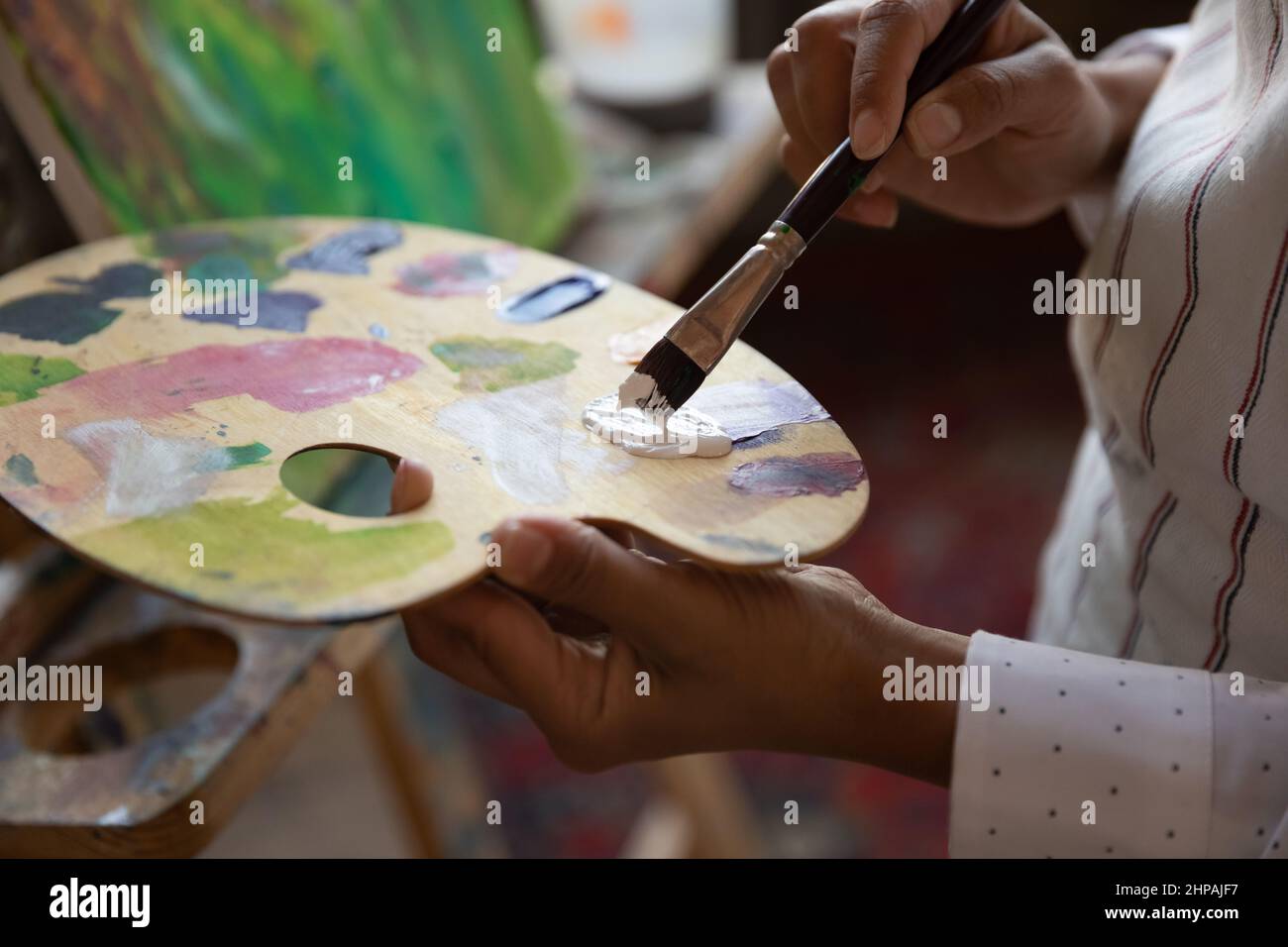 Close up focus on palette with mixed paints. Stock Photo