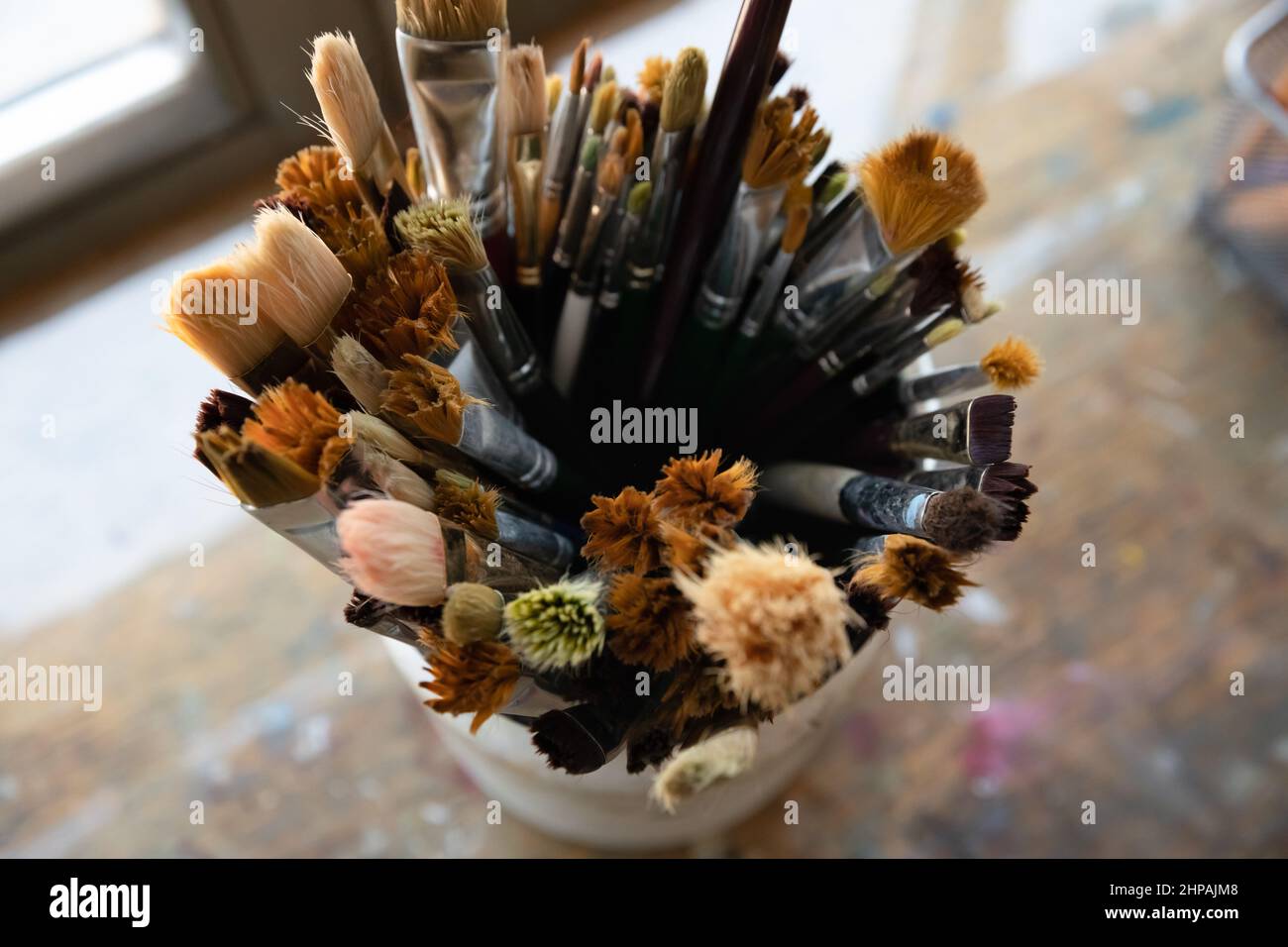 Top close up view on focus on paintbrushes in organizer. Stock Photo