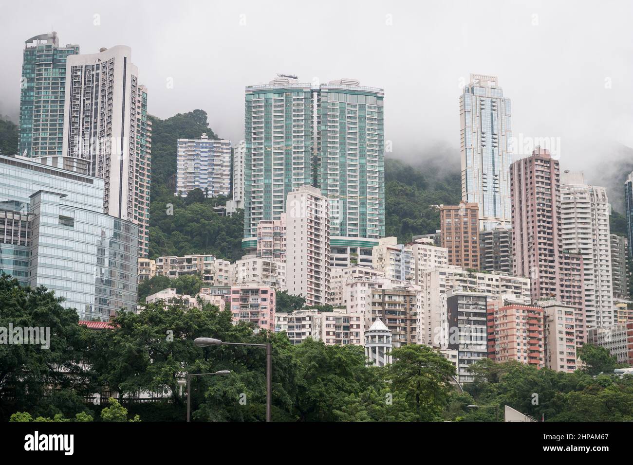 Highrise residential buildings in Mid-Levels, below The Peak hidden by low cloud, Hong Kong Island, 2008 Stock Photo