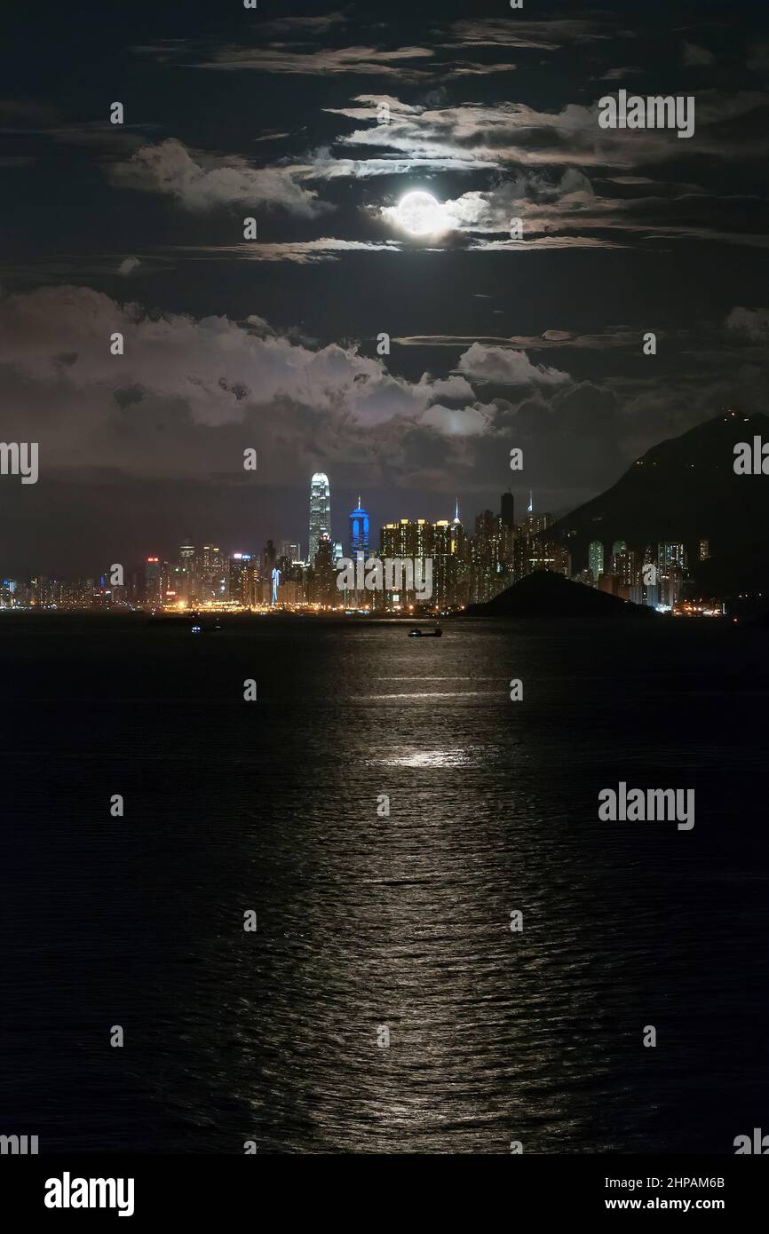 Moonrise over Central, Hong Kong Island, seen from Discovery Bay, Lantau Island, Hong Kong Stock Photo