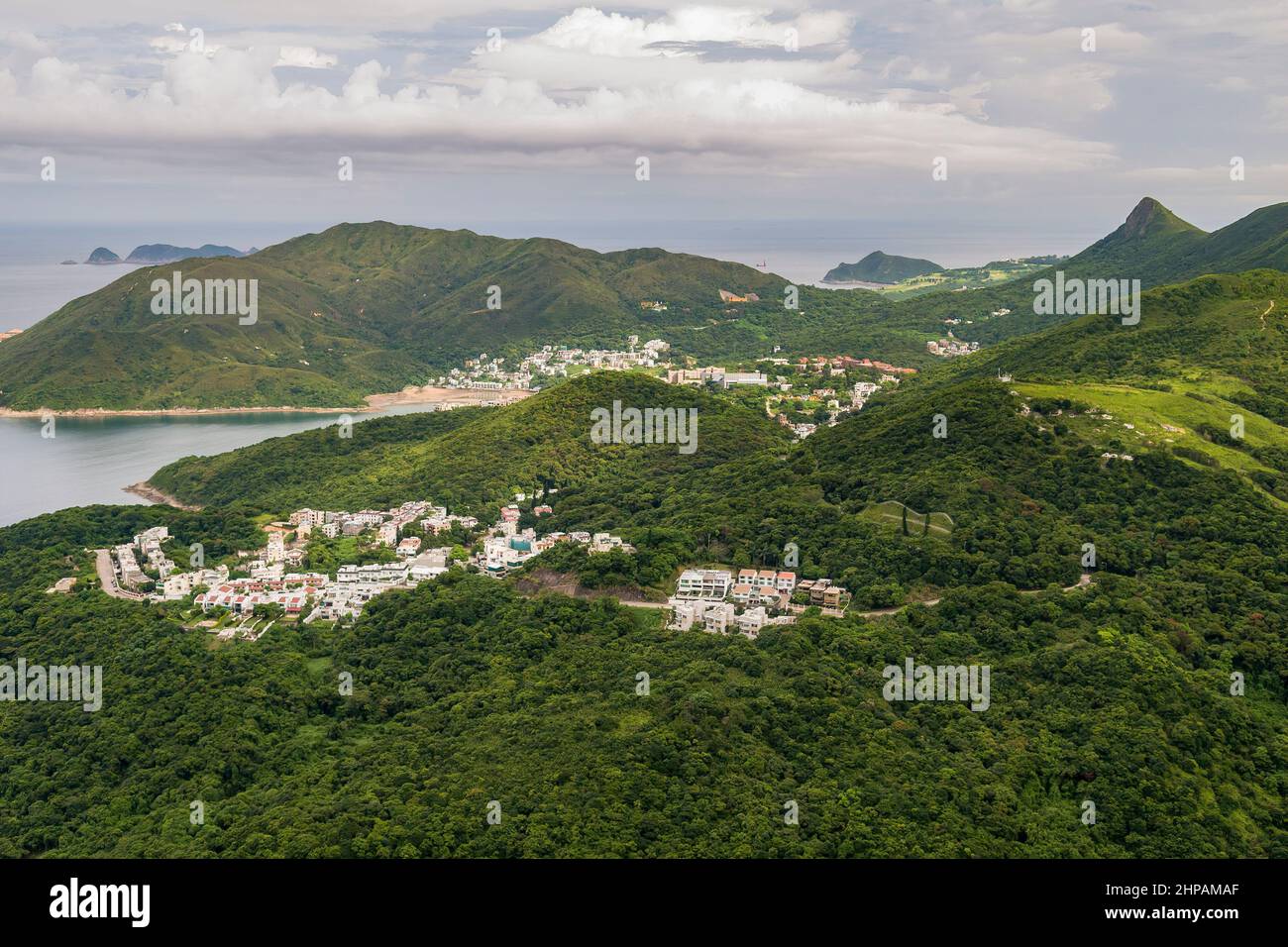 Aerial from helicopter showing houses in the Clear Water Bay peninsula, looking south to High Junk Peak and the South China Sea, Hong Kong, 2008 Stock Photo