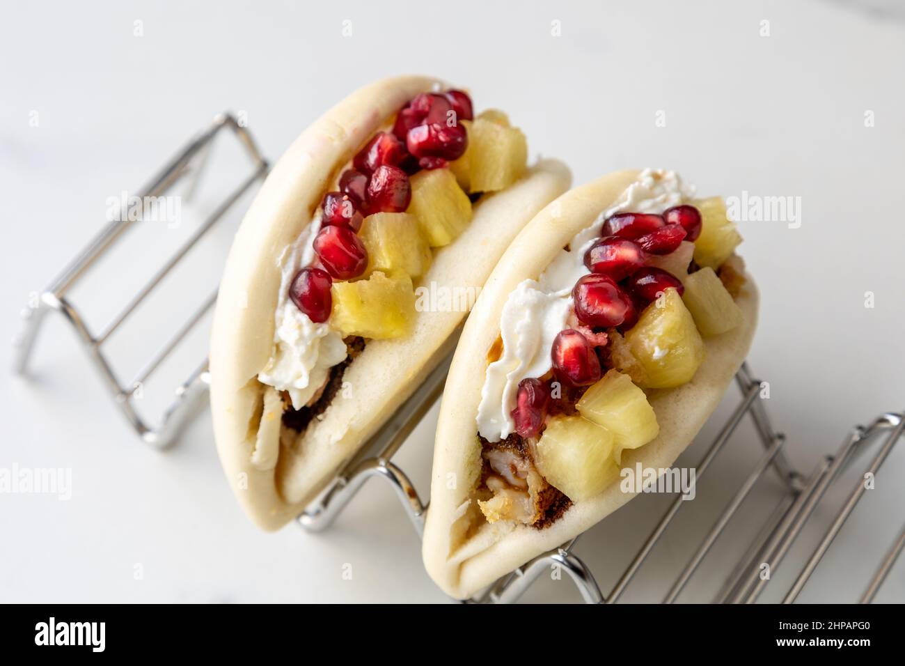 Portions of baos with cream and pineapple Stock Photo