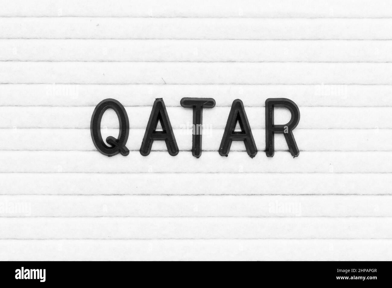 Black color letter in word qatar on white felt board background Stock Photo