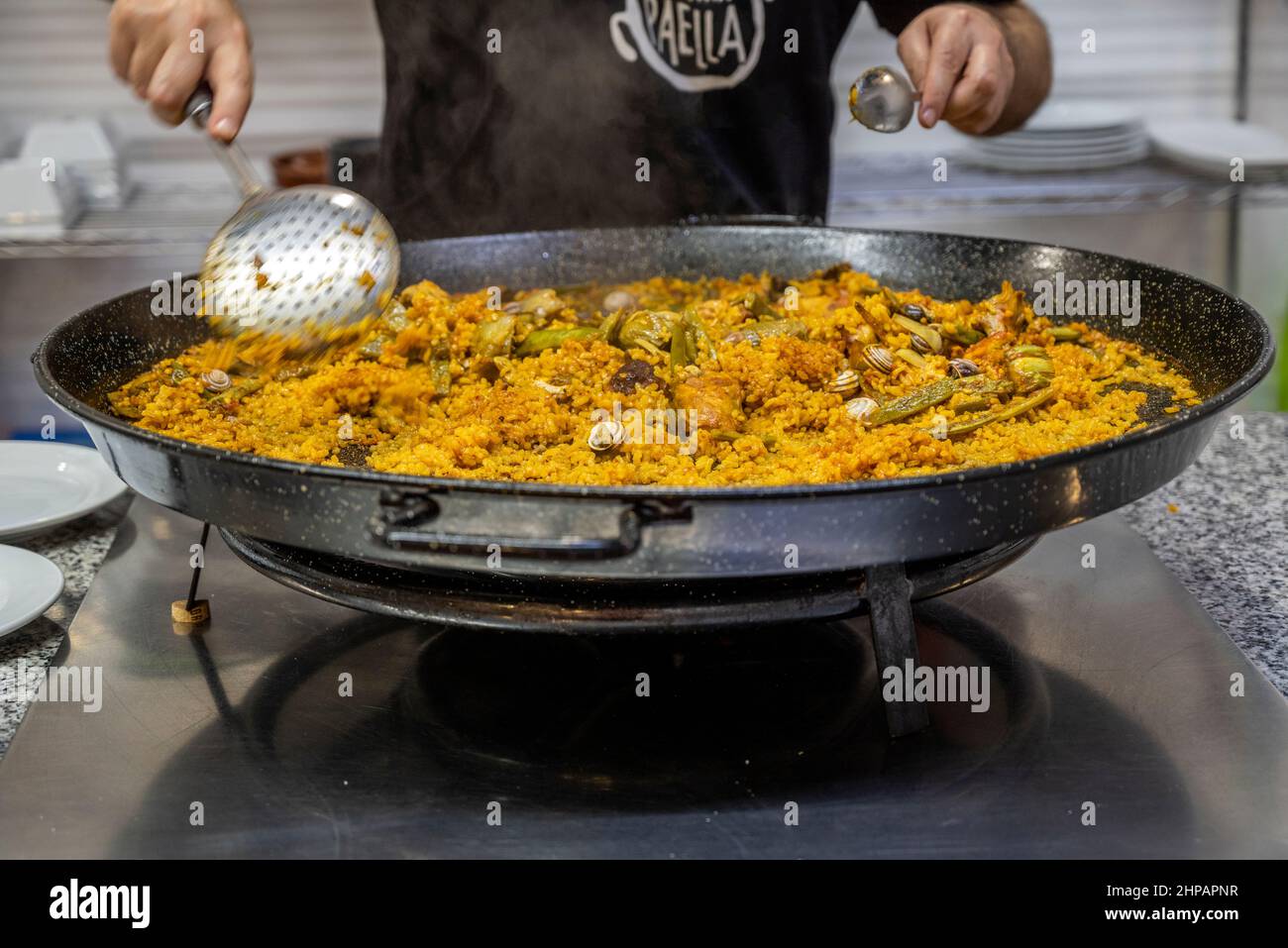 Cook preparing a paella valenciana, Valencia, Spain Stock Photo