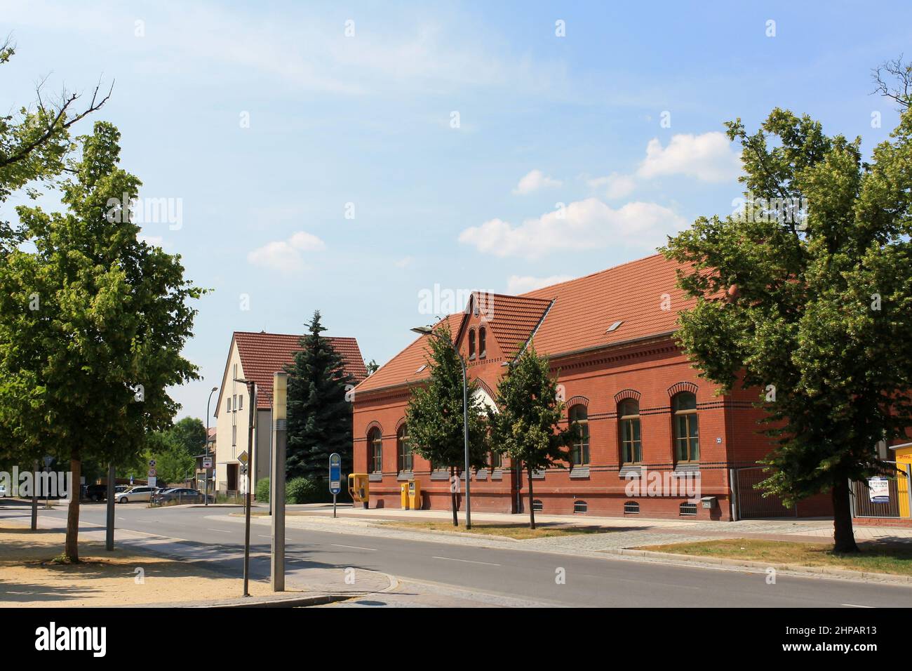 View of old building exterior in summer at Stendal train station in Germany with clouds in blue sky background. No people. Stock Photo