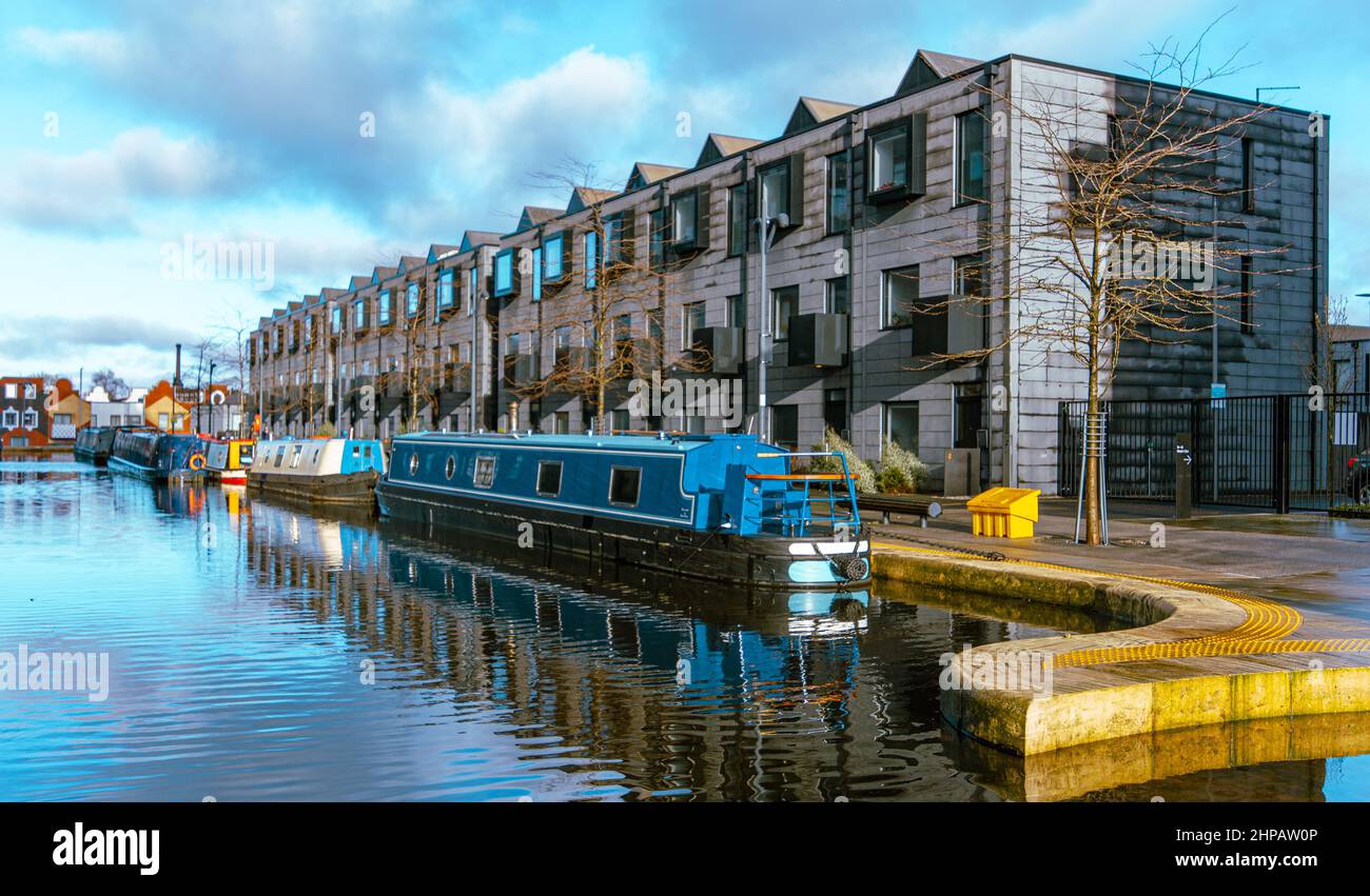 Modern housing and narrow boats share the same site in the newly developed New Islington area of Manchester, England, UK Stock Photo