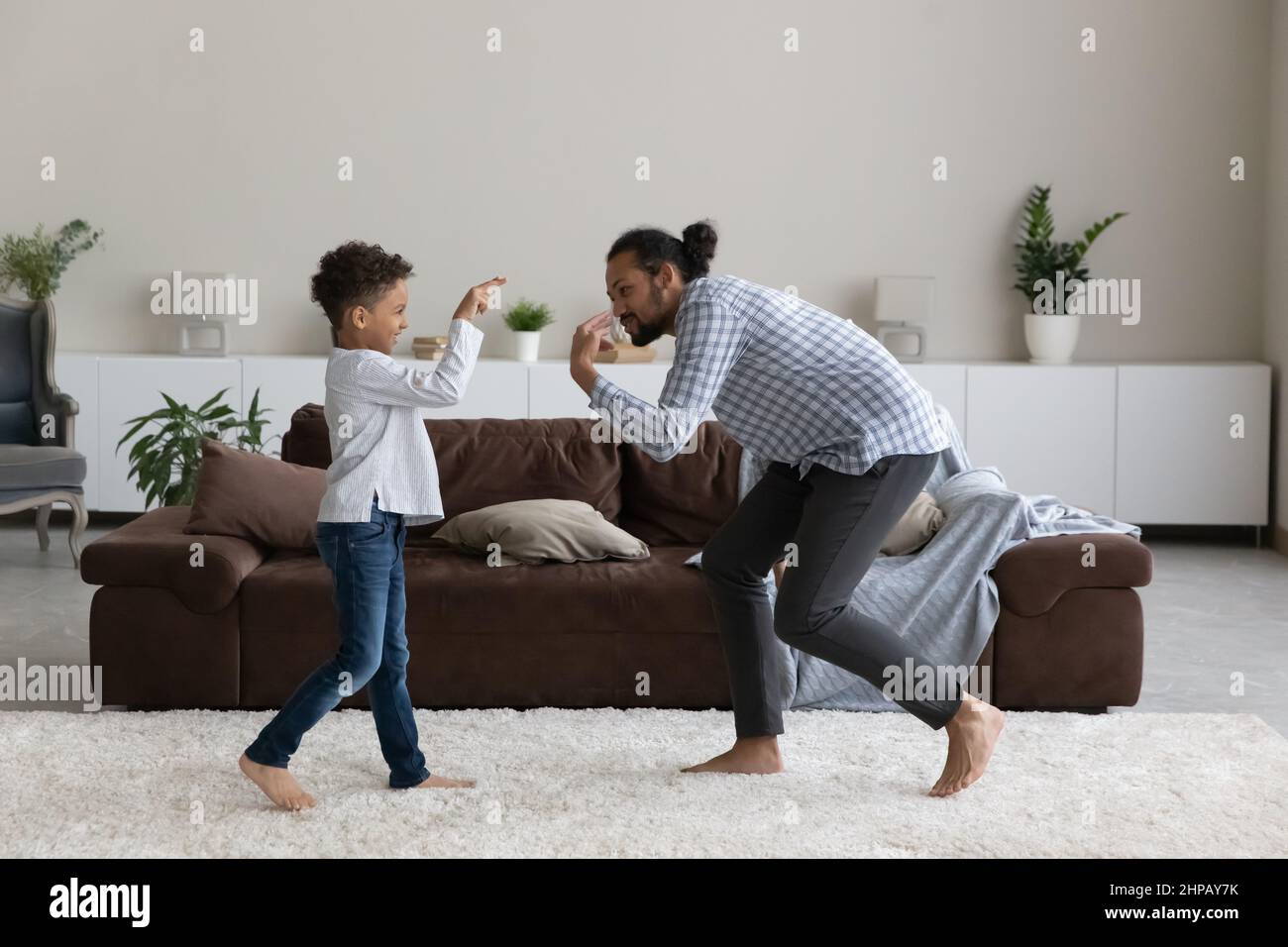 Happy small African American boy dancing with caring father Stock Photo