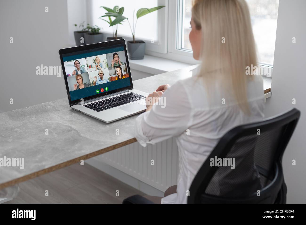 Caucasian female teacher using computer and laptop on video call with ...