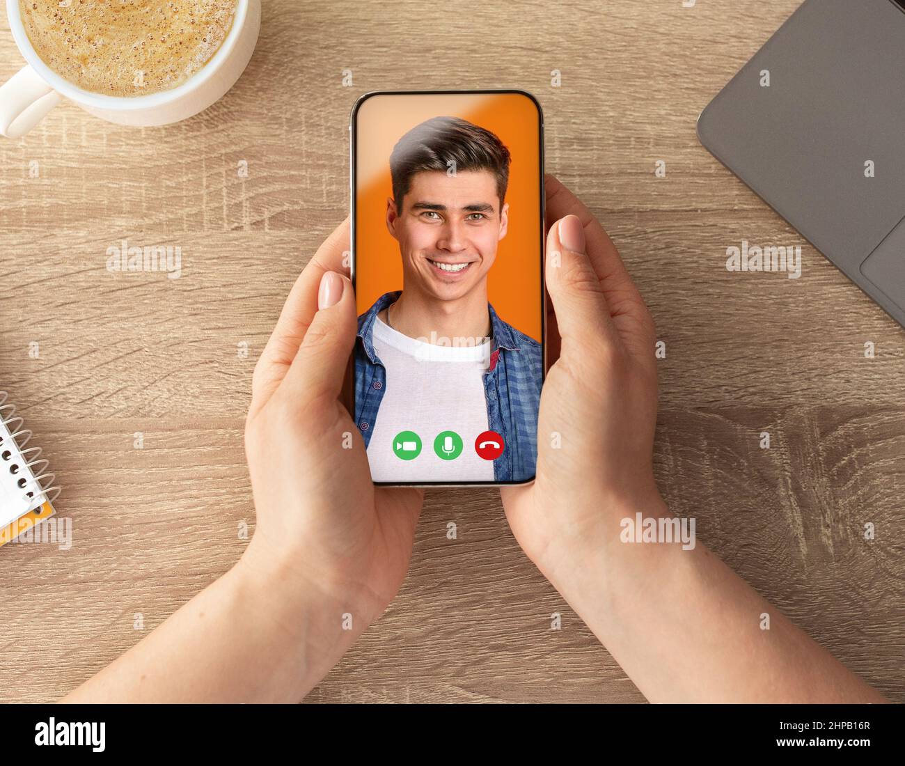 POV Of Woman Using Smartphone To Video Chat With Handsome Young Guy Stock Photo
