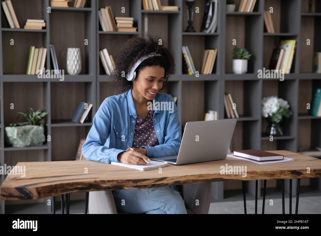 Happy African American woman in headphones studying online Stock Photo ...