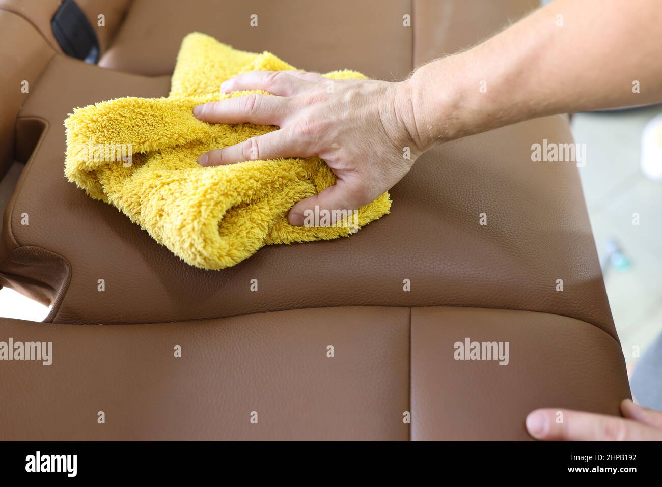 Man cleaning leather car seat with microfiber cloth Stock Photo Alamy
